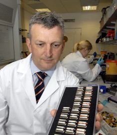 Dale Athey, holding a tray of biosensors